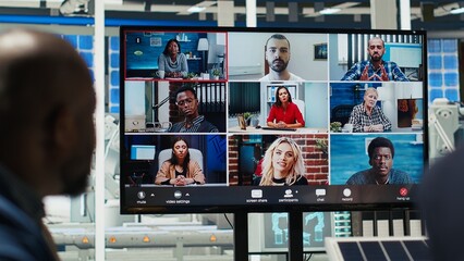 Photovoltaics plant shareholders analyze market trends during online videocall to determine...