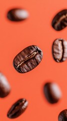Fototapeta premium Roasted coffee beans floating against a vibrant orange background