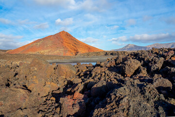 Red mountain. Red mountain contrasting with black volcanic terrain, Canary Islands, Lanzarote, Spain