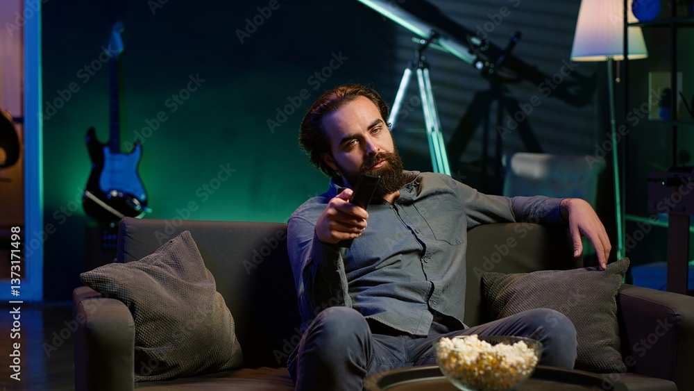 Aufkleber man using remote to switch channels on television screen, feeling frustrated by uninteresting conten