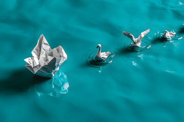 Paper swan leadership journey, turquoise water