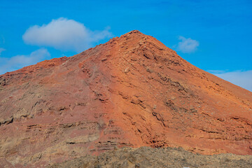 Red mountain. Red mountain contrasting with black volcanic terrain