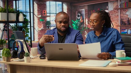 African american people at home entering card digits to renew an account subscription, managing...