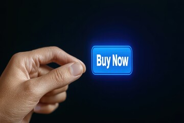 Hand holding blue buy now button with glowing effect