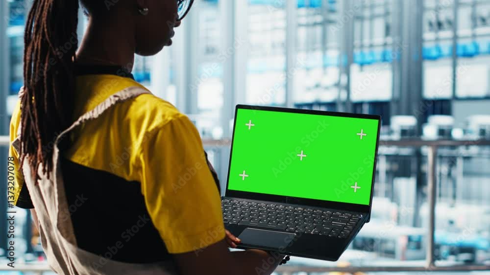 Poster smart factory specialist using mockup laptop to test automated systems and ensure reliability. woman