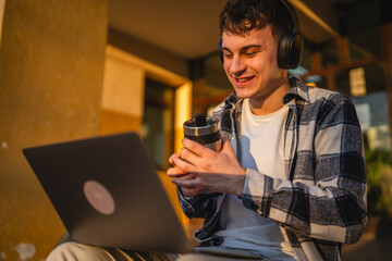man student sit on stairs outdoor and use laptop, prepare for class