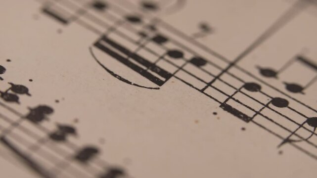 Slider macro footage of Mozart aged book with music notes sheet. Archival manuscripts, vintage musical score for piano. Educational symbols for musician