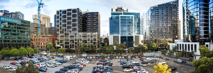 Panoramic view of multiple modern high-rise apartment buildings and office towers, with a large...