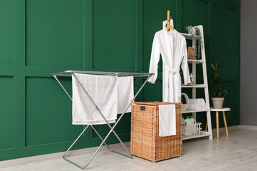 Interior of room with laundry basket, dryer and shelf unit