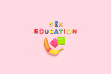 Text SEX EDUCATION with condoms and banana on pink background