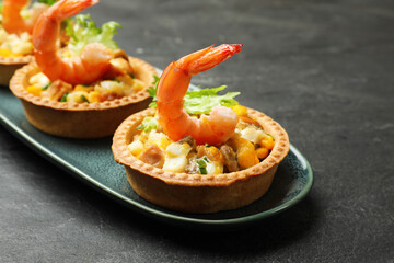 Tartlets with delicious filling on black table, closeup