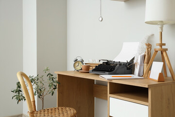 Vintage typewriter and lamp on table in author's office