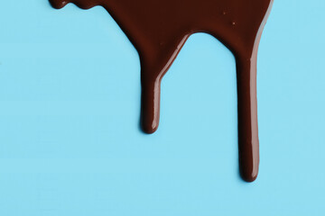 Sweet chocolate splash on blue background
