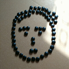Black Beads Arranged as Smiley Face

