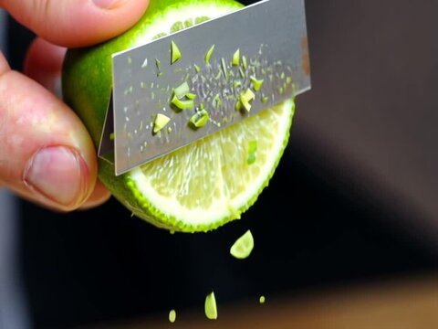 Zesting a Fresh Lime with a Zester in Slow Motion Kitchen Prep