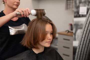 Fototapeta premium The Salon Hair Styling Process involves the expertise of a Professional Hairdresser