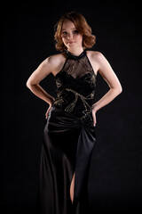 This evening dress showcases an elegant design worn by a stunning model in a captivating pose