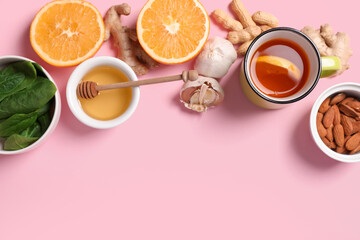 Composition with different healthy food and cup of tea on pink background. Immunity boosting concept