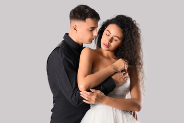 Young wedding couple hugging on light background. Yin Yang concept