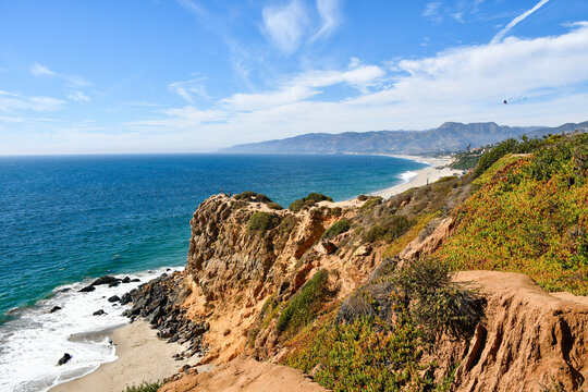 View from a hiking trail overlooking rocky cliffs and Pacific Ocean at Point Dume State Beach