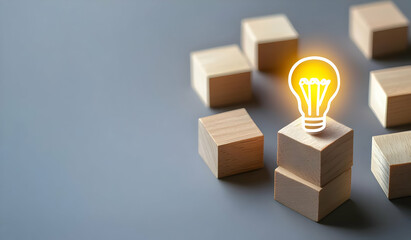 A creative representation of innovation with illuminated light bulb on wooden blocks emphasizing ideas and solutions.