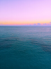 Aerial view of colorful sunset over ocean in Punta Cana.Breathtaking scenery showcases sky painted with stunning hues, while gentle waves reflect evening light. Postcard capturing beauty of tropical