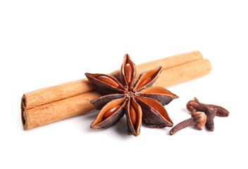 Anise star with cinnamon and cloves on white background