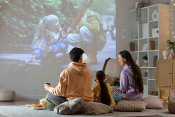 Family watching movie together at home
