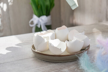 Unrecognizable woman creating Easter holiday decoration from sustainable materials egg shell. Diy do it yourself step by step instruction. Gift present idea Crafting preparation holiday