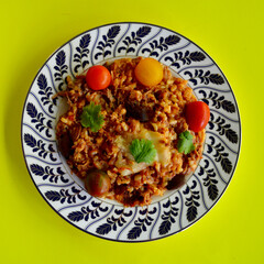 Beef and black olive risotto with tomatoes cheese and parsley. 
