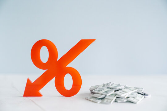 Red down arrow and percentage with cash money, global economy downturn, inflation, stagflation, economic crisis concept