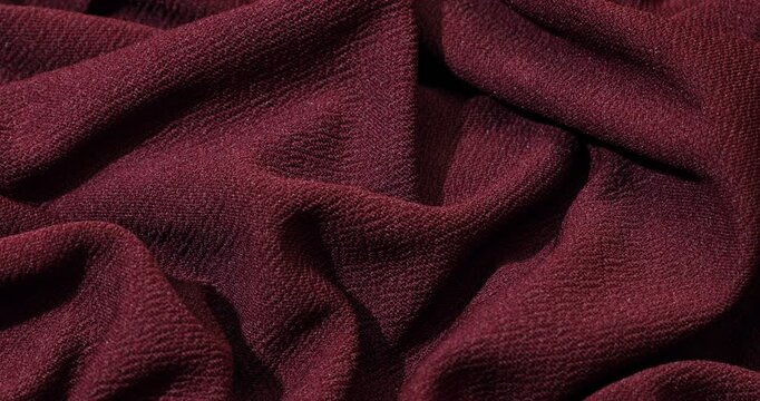 Burgundy fabric background. Burgundy cloth waves background texture. Burgundy fabric cloth textile material.