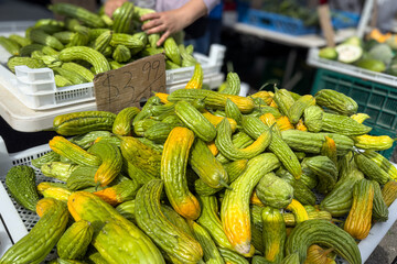 Bitter Melons for sale at an outdoor market. At Avondale Sunday Market in Auckland. New Zealand's...