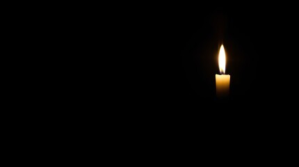 A single candle burning in the darkness, representing solitude, hope, and the power of light. The gentle flicker of the flame evokes warmth and contemplation in a mysterious atmosphere.

