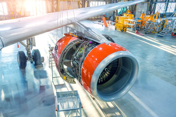 Open engine cowling of an airplane in a hangar, repair and maintenance in civil aviation, top view...
