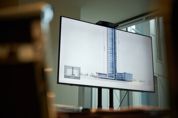 Low angle view no people shot of skyscraper image on screen in board room in modern office, copy...