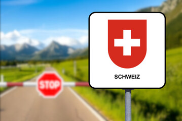Swiss border, sign Switzerland and a border post with a barrier and stop sign
