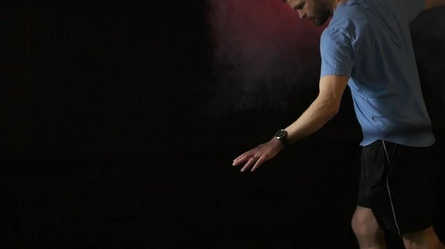 Isolated Male padel player serving ball and follow up motion in padel tennis. Slow motion