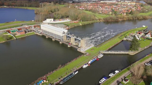 Aerial view of a river sluice gate in England managing water levels.