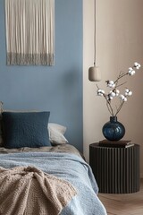 A cozy bedroom with a cotton branch in a decorative vase, warm textiles, and a mix of organic and modern design elements.