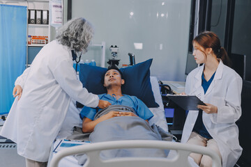 Nurse giving assistance to senior patient with disease in bed. Medical assistant and doctor doing...