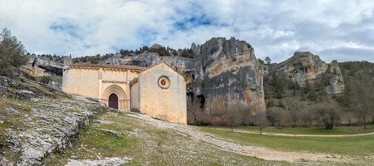 Ancient Stone Chapel Surrounded by Majestic Cliffs