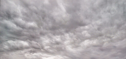 Aerial perspective of a turbulent sky filled with storm clouds, taken by drone