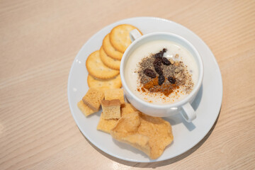 Top view of soup bowl and bread on wooden background