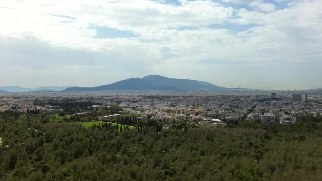 Aerial wide panorama shot, panning from Ymittos to Penteli mountain, Attica Basin 4K