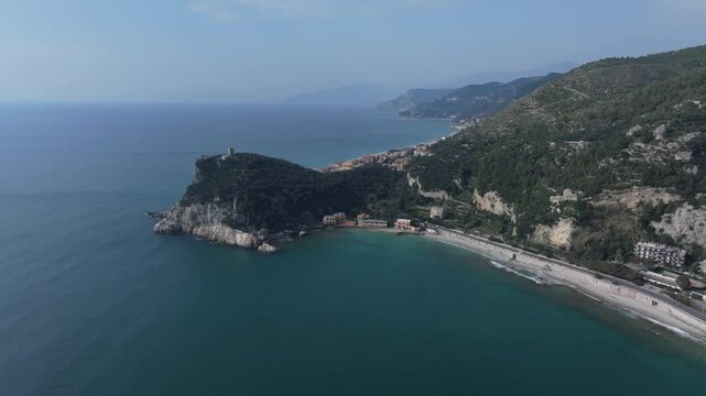 aerial of Spiaggia del Malpasso beach shot sideways, moving inland toward the coast of Italy