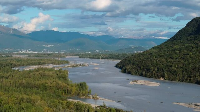 sideways aerial of the Tagliamento braided river in northern Italy showcasing the mountains and wide river