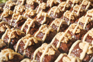 Delicious turkish baklava decorated with creamy topping and nuts
