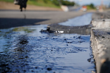 Low-angle detailed shot of hot bitumen coating on fresh asphalt, showcasing texture and close-up details at highway construction site