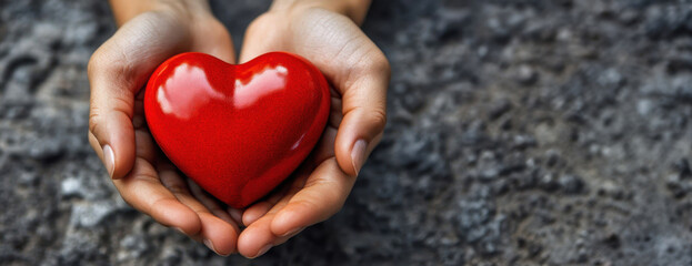 Obraz premium Emotional connection female hands holding a vibrant red heart in clean environment